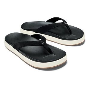OluKai Nu'a Pi'o thong sandals in black synthetic material with a white sole